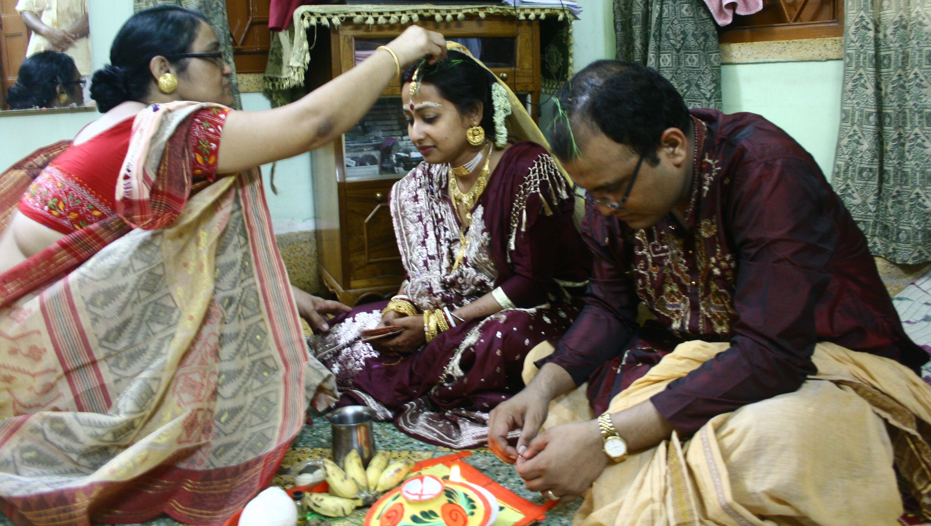 Sourav and Arpita at Sourav's house with Sourav's mother. This ceremony is called Baron which means the acceptance